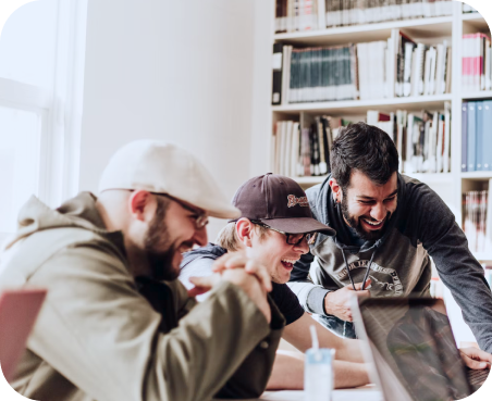 Three men looking at laptop computer