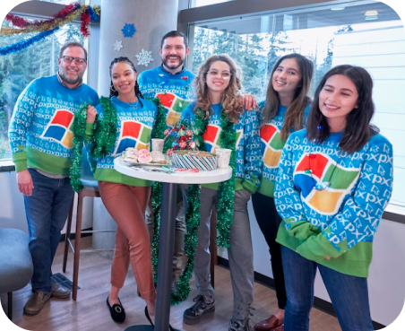 Group of people wearing same sweater with brand logo