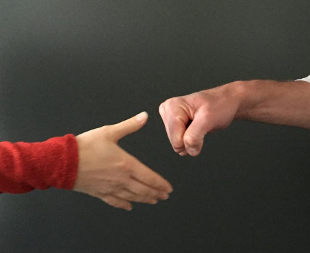 Two playing rock-paper-scissors